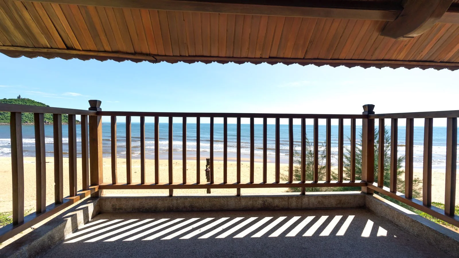 A wooden balcony overlooking a quiet beach, the asset an owner is deciding whether to trust you with.