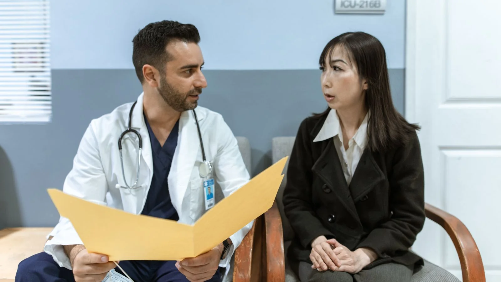 A clinician in consultation with a patient, the conversation wellness centers photograph but never describe