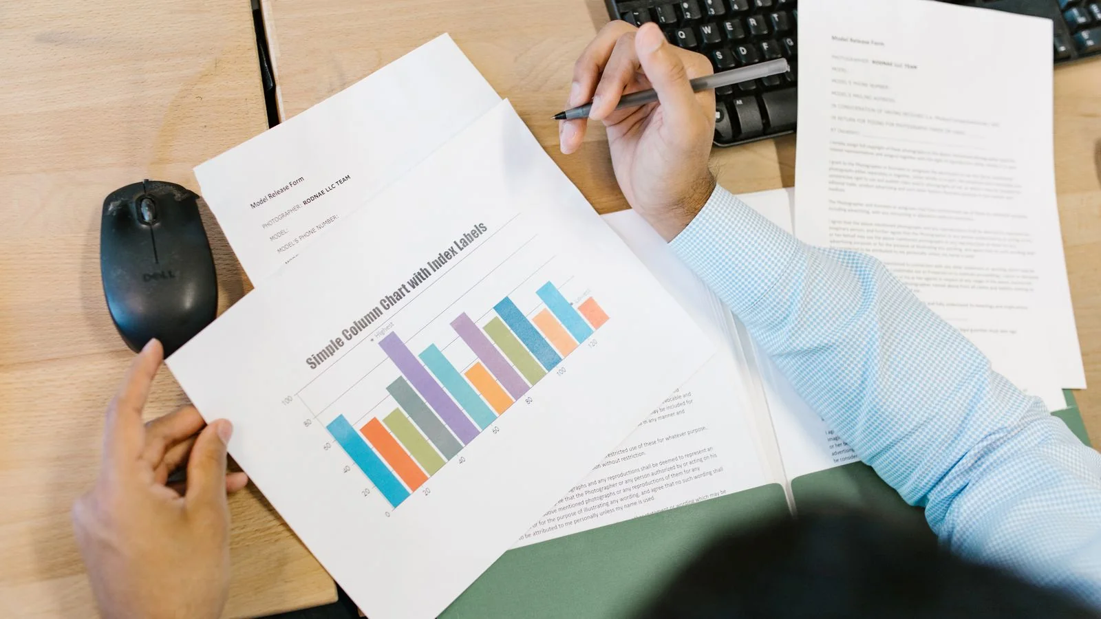 A business analyst reviewing a printed bar chart at a desk, the kind of borrowed data most posts lean on