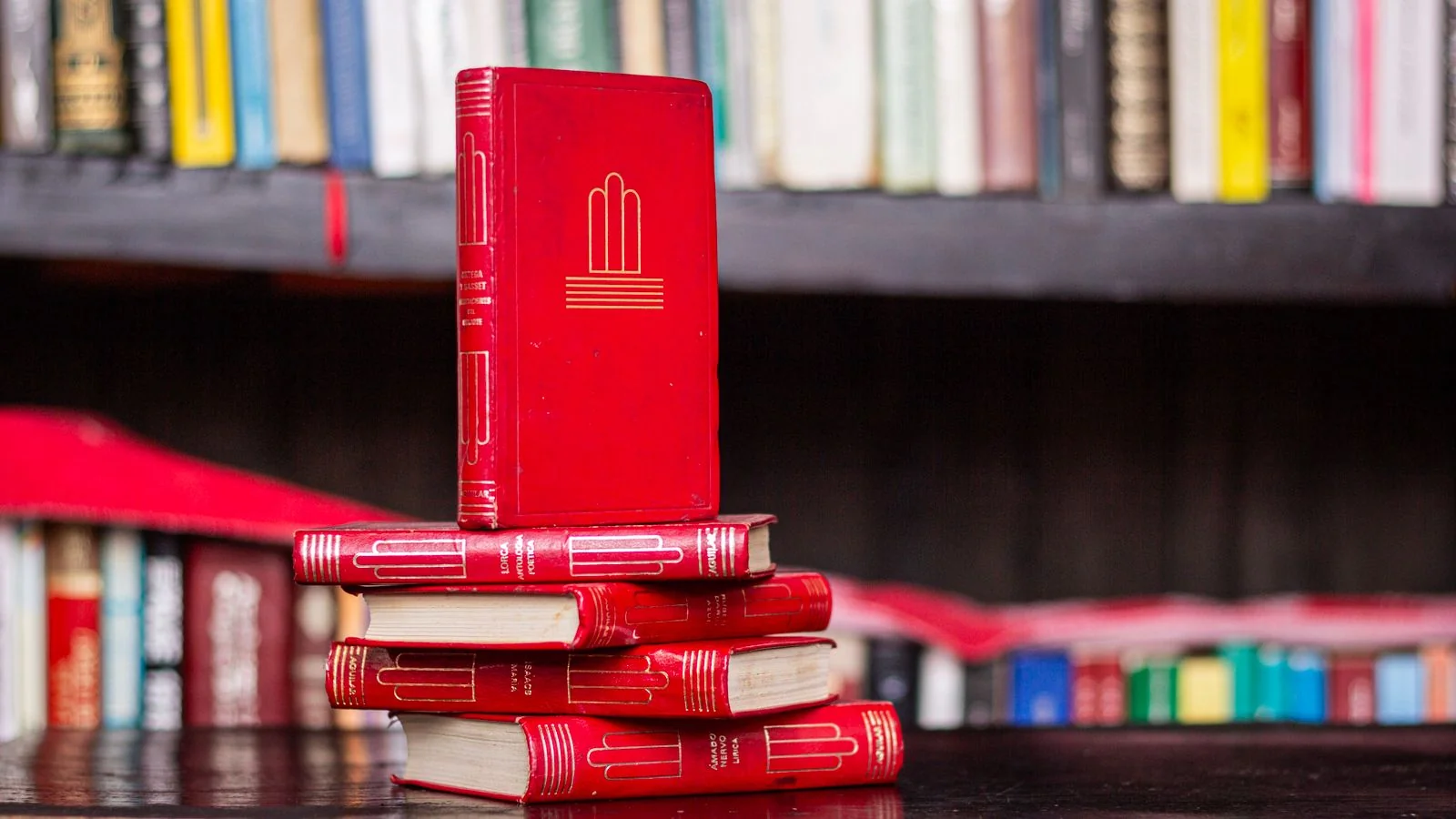 Rows of red books in a library, the connected coverage a cluster ledger tracks toward topical authority
