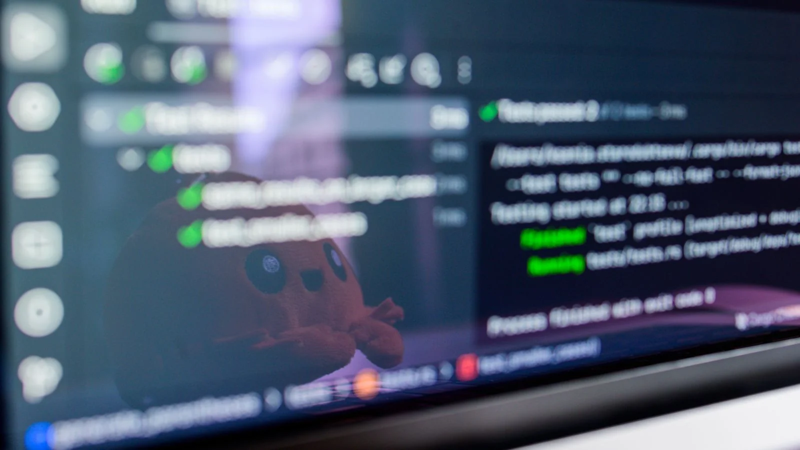 Code on a laptop screen with a plush toy reflected, the unglamorous reality of a replatform