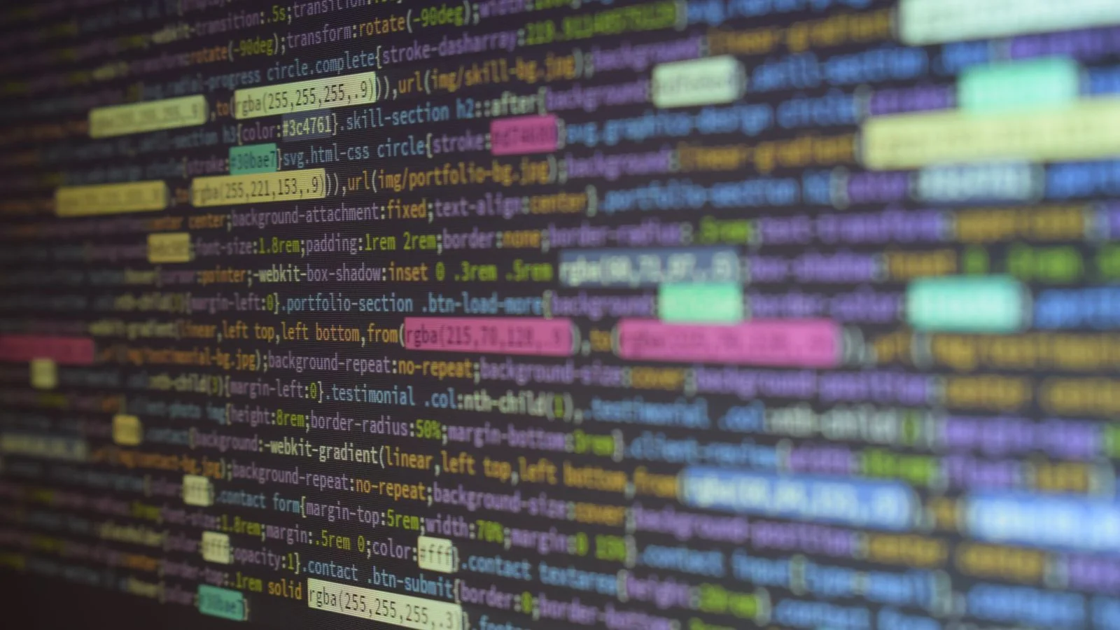 Colorful source code on a monitor, representing Organization and Person schema markup with sameAs links