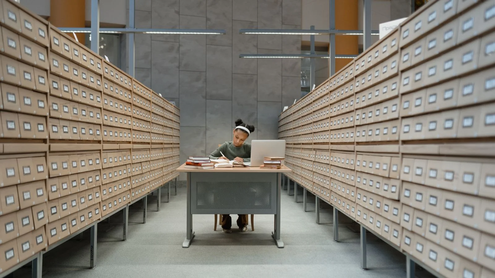 A researcher taking notes in a library, the independent sourcing work that qualifies an entity for Wikidata