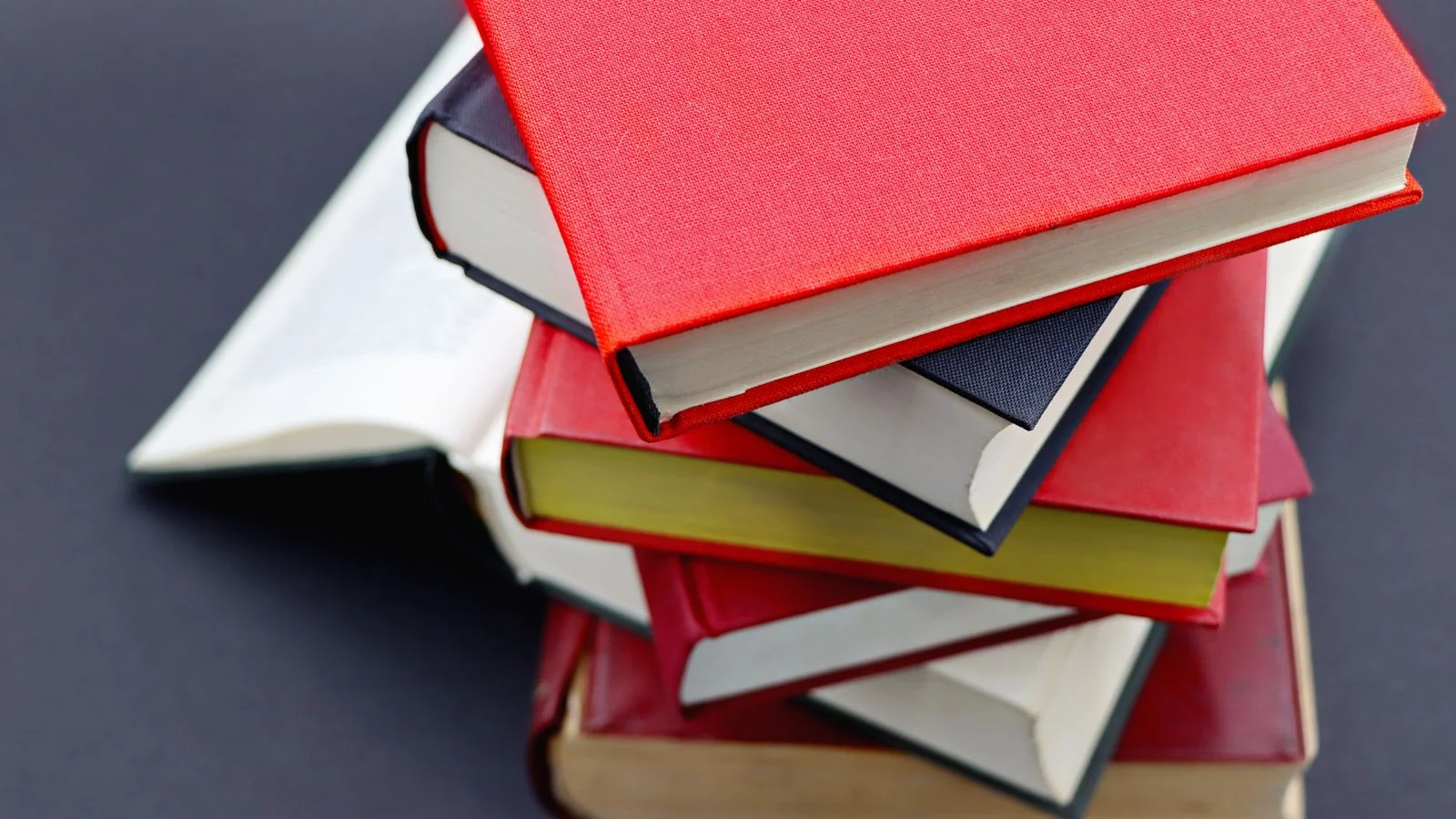 Pile of hardcover books with colorful covers, the kind of published sources Wikidata trusts