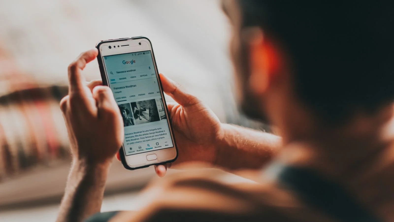 A person reading content on a phone, the zero-click moment where the answer lands without a visit