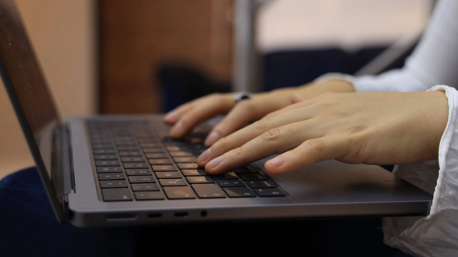 Hands typing on a laptop keyboard, the moment before a search that increasingly ends without a click