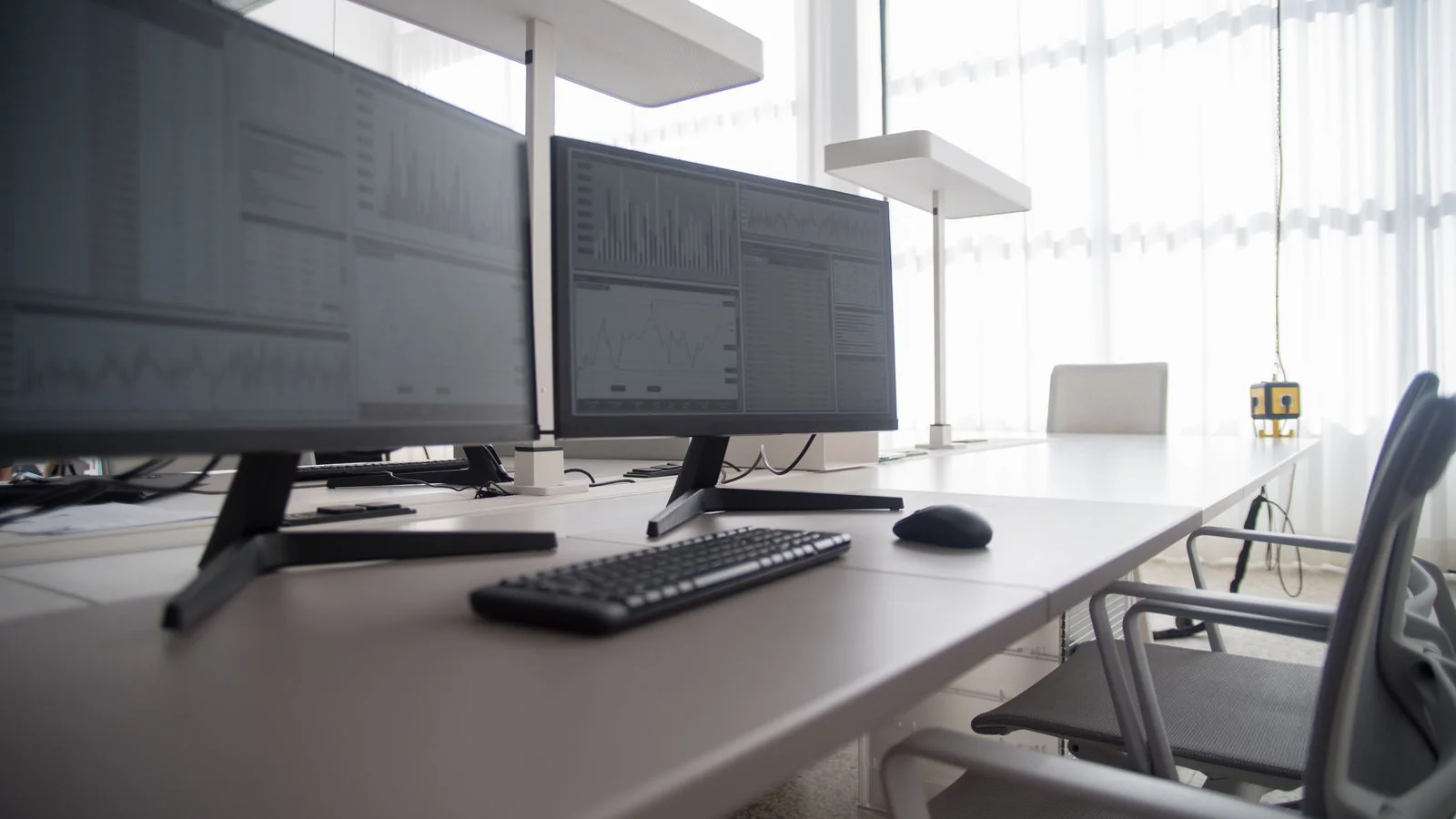 Modern workspace with two monitors on a desk, the kind of setup where search now answers questions in place